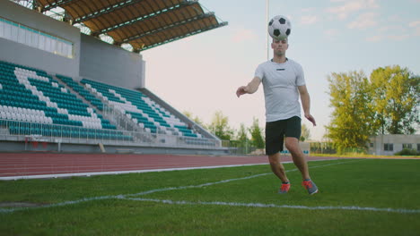 A-football-player-in-equipment-on-the-football-field-receives-a-pass-and-technically-handles-the-incoming-soccer-ball